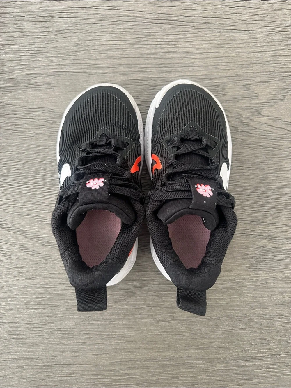 Nike Kids Black Sneakers with White & Red Swoosh and Pink Flower Accents